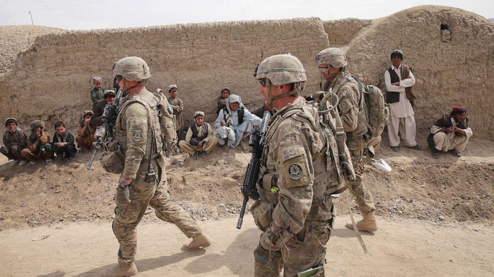 PHOTO: Soldiers with the U.S. Army's 4th squadron 2d Cavalry Regiment walk through a village during a joint patrol with soldiers from the Afghan National Army (ANA) on March 2, 2014, near Kandahar, Afghanistan.