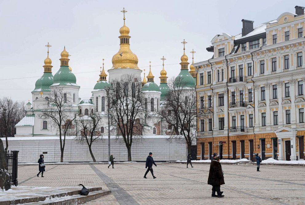 PHOTO: People walk past Saint Sophia Cathedral at Sophia Square in Kyiv, Ukraine on Jan. 25, 2022.