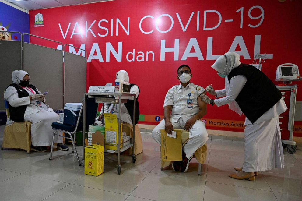 PHOTO: A health worker receives a dose of the Moderna COVID-19 vaccine donated by the US, during a booster vaccination drive at the Zainoel Abidin hospital in Banda Aceh on Aug. 9, 2021.