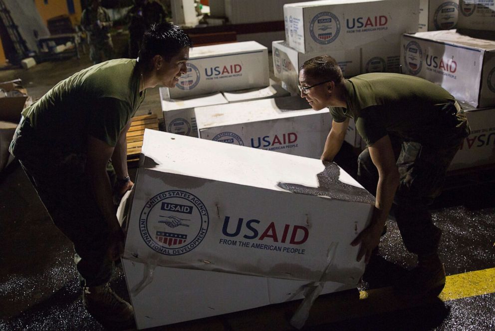 PHOTO: U.S. Marines assigned to Joint Task Force - Leeward Islands stack boxes of tarps from the U.S. Agency for International Development in Melville Hall, Dominica, Sept 29, 2017.