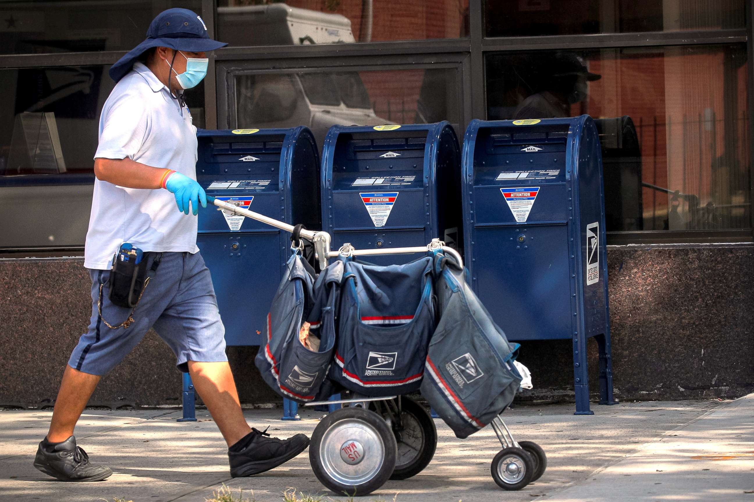 PHOTO: A mail carrier delivers mail in the Brooklyn, NY, Aug. 21, 2020.