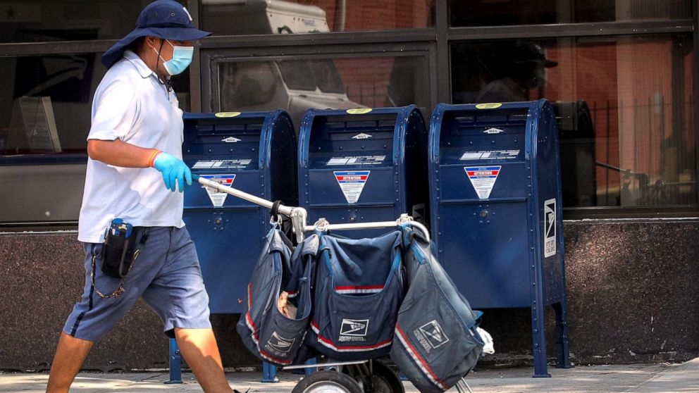 PHOTO: A mail carrier delivers mail in the Brooklyn, NY, Aug. 21, 2020.