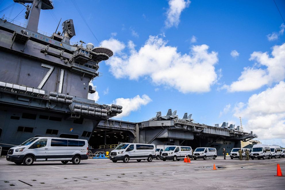 PHOTO: U.S. Navy personnel coordinate transportation of Sailors assigned to the aircraft carrier USS Theodore Roosevelt who have tested negative for COVID-19, April 10, 2020.