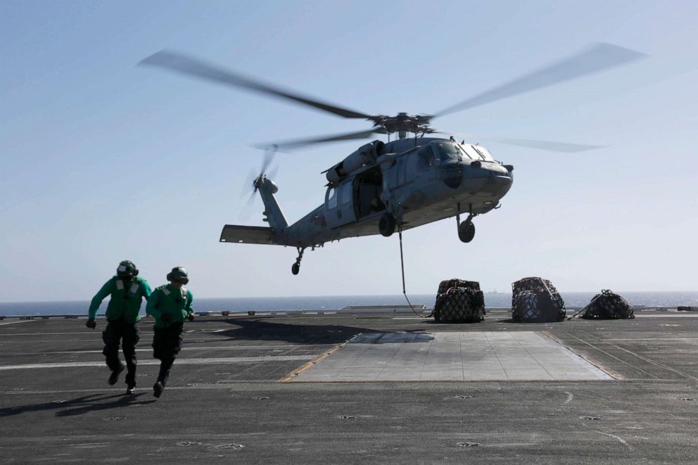 PHOTO: U.S. Navy, Logistics Specialist attach cargo to an MH-60S Sea Hawk helicopter from the flight deck of the Nimitz-class aircraft carrier USS Abraham Lincoln (CVN 72) May 10, 2019 in the Red Sea.