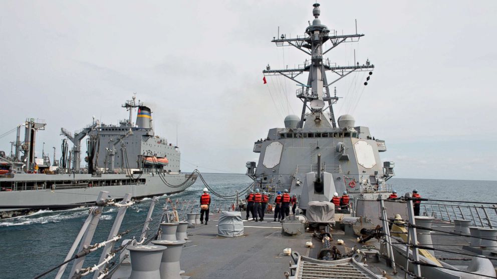The forward-deployed Arleigh Burke-class guided-missile destroyer USS Mustin conducts a replenishment at sea with the Military Sealift Command Fleet Replenishment Oiler USNS John Ericsson in the Java Sea in this Jan. 29, 2016 file photo.