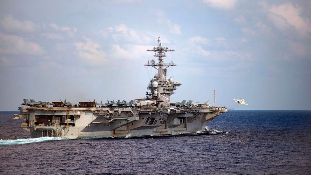 PHOTO: An F/A-18F Super Hornet, assigned to the Black Knights of Strike Fighter Squadron (VFA) 154, launches from the flight deck of the aircraft carrier USS Theodore Roosevelt (CVN 71), March 18, 2020, in the Pacific Ocean.