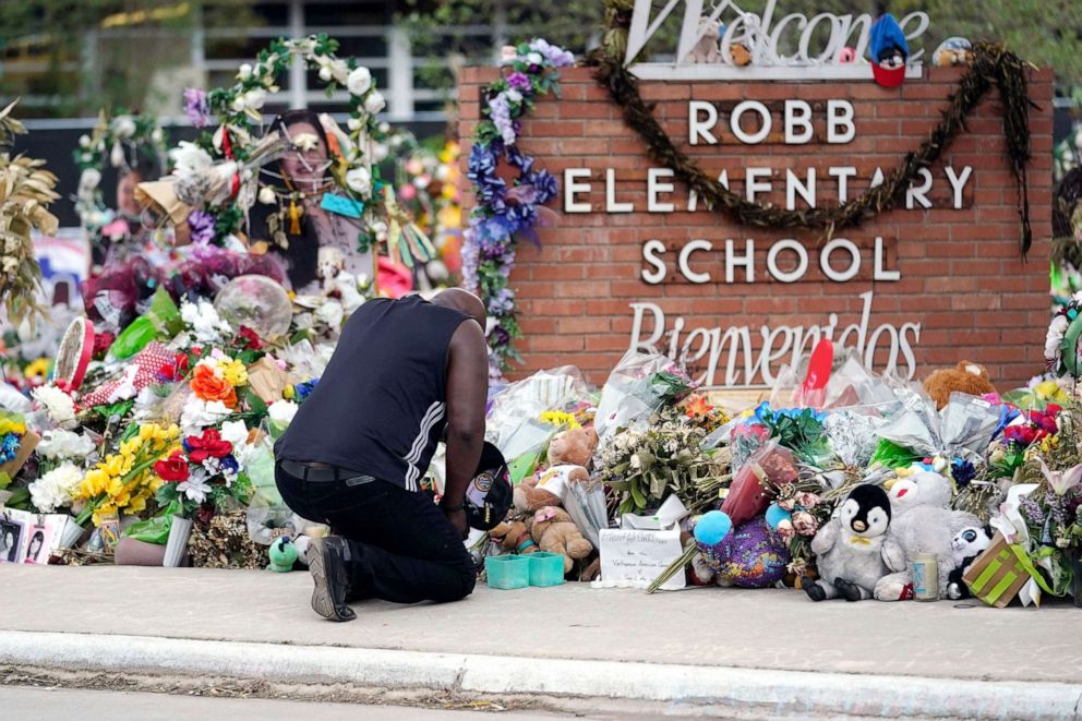 PHOTO: A person pays respects at a memorial at Robb Elementary School on June 9, 2022, in Uvalde, Texas.