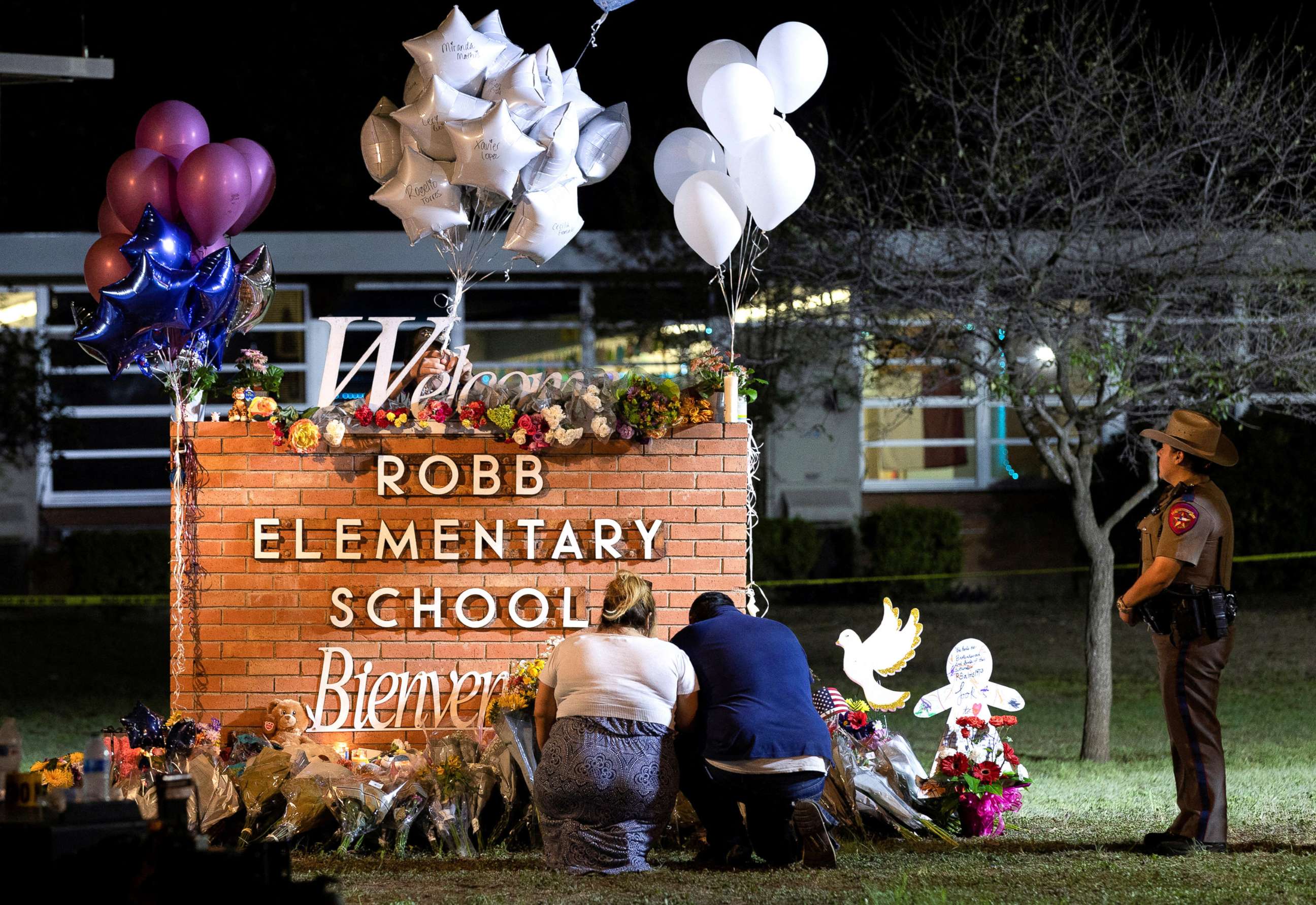 PHOTO:  Stephanie and Michael Chavez of San Antonio pay their respects at a makeshift memorial outside Robb Elementary School, the site of a mass shooting, in Uvalde, Texas, May 25, 2022. 