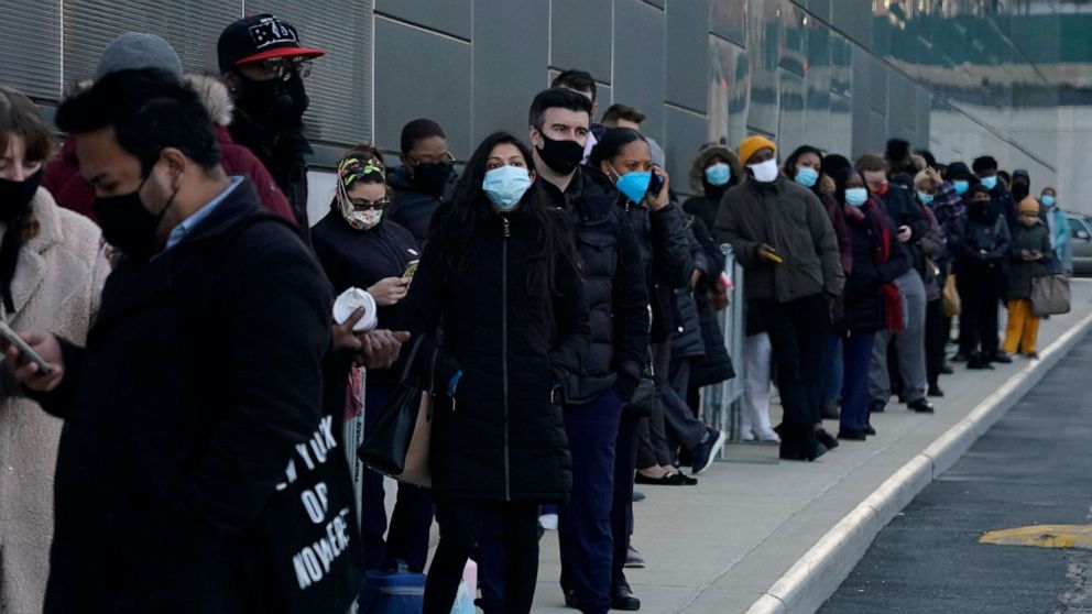 PHOTO: People line up early at the Jacob Javits Convention Center COVID-19 vaccination hub on March 4, 2021.