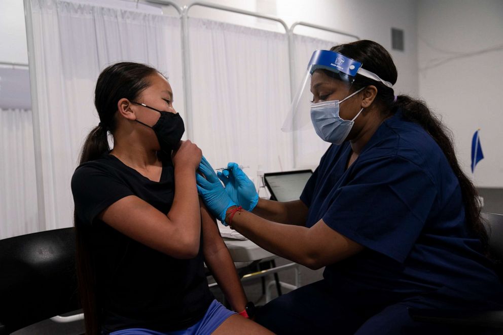 PHOTO:Payton Nguyen, 12, receives the Pfizer COVID-19 vaccine from nurse Lakera Thorne at Providence Edwards Lifesciences vaccination site in Santa Ana, Calif., , May 13, 2021. 