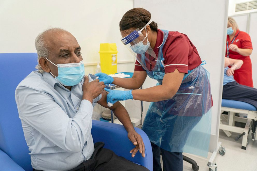 PHOTO: Home care worker Pillay Jagambrun receives the Pfizer/BioNTech COVID-19 vaccine in south London, Dec. 8, 2020. 