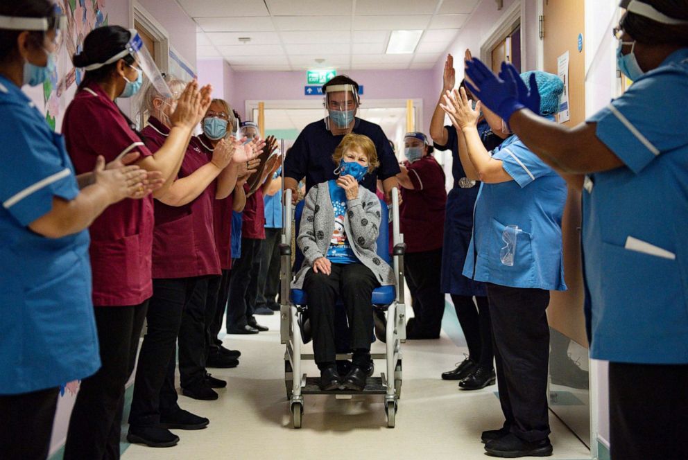 PHOTO: Margaret Keenan, 90, is applauded by staff as she returns to her ward after becoming the first patient in the UK to receive the Pfizer-BioNTech COVID-19 vaccine, at University Hospital, Coventry, England, Dec. 8, 2020.