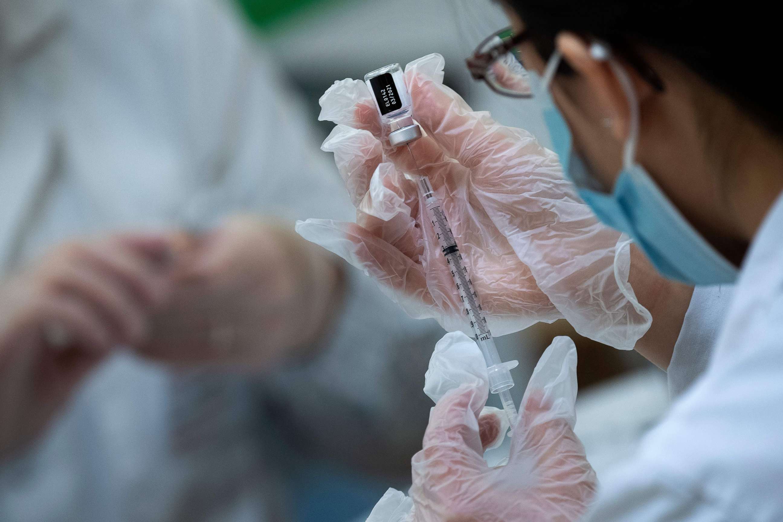 PHOTO: A pharmacist dilutes the Pfizer COVID-19 vaccine while preparing it to administer to staff and residents at the Goodwin House Bailey's Crossroads, a senior living community in Falls Church, Va., Dec. 30, 2020. 