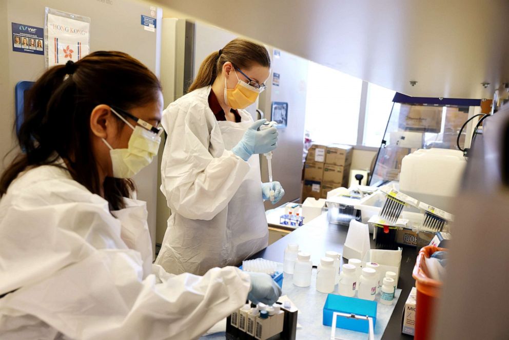 PHOTO: Medical lab scientists work on samples collected in the Novavax phase 3 Covid-19 clinical vaccine trial conducted at the Harborview Medical Center on Feb. 12, 2021, in Seattl
