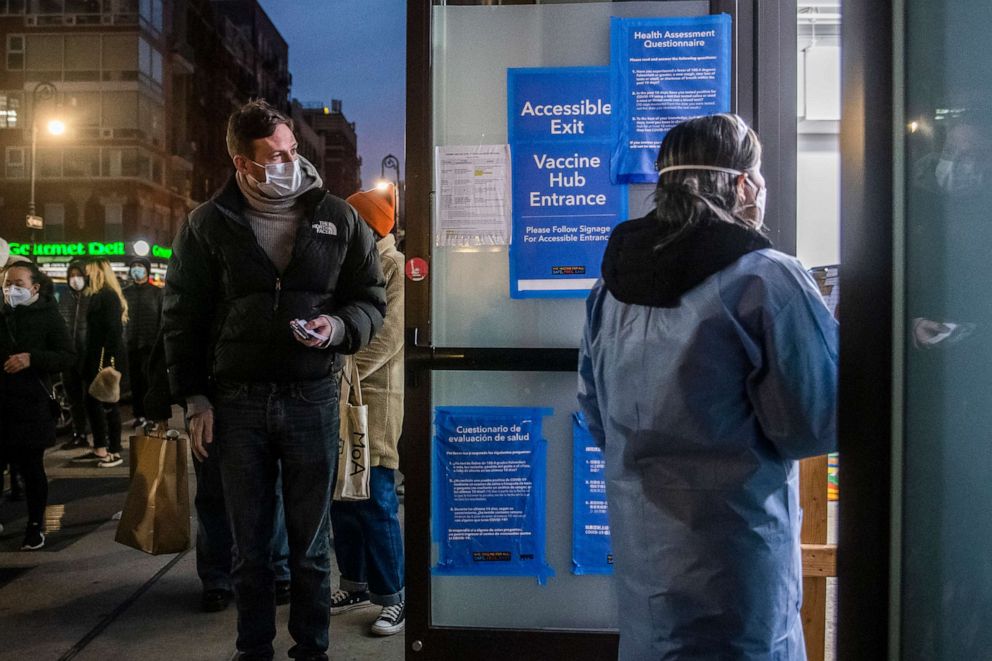 PHOTO: People wait on line to get vaccinated for COVID-19, Dec. 21, 2021, in New York.