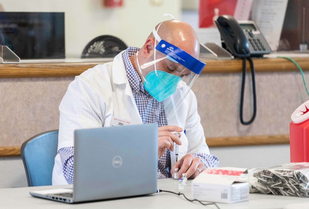 PHOTO: A pharmacy manager at CVS Health prepares COVID-19 vaccine doses at the Soldiers' Home in Holyoke, Mass., Dec. 29, 2020.