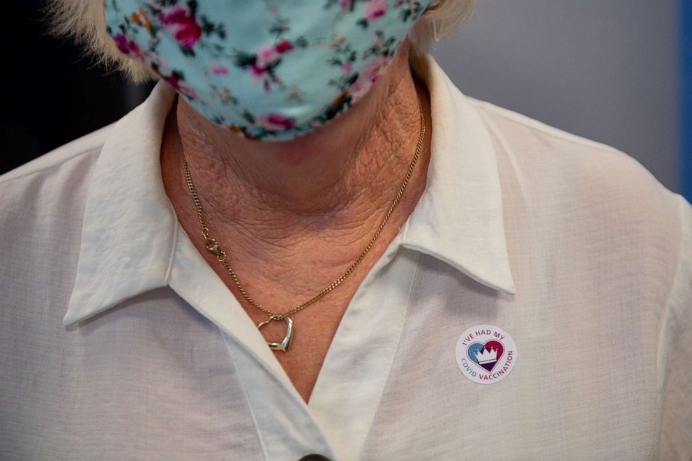 PHOTO: Maureen Hughes, 84, receives a sticker after getting the first of two injections with a dose of the Pfizer/BioNtech covid-19 vaccine at Feldon Lane Surgery in Halesowen, West Midlands, England, Dec. 14, 2020.