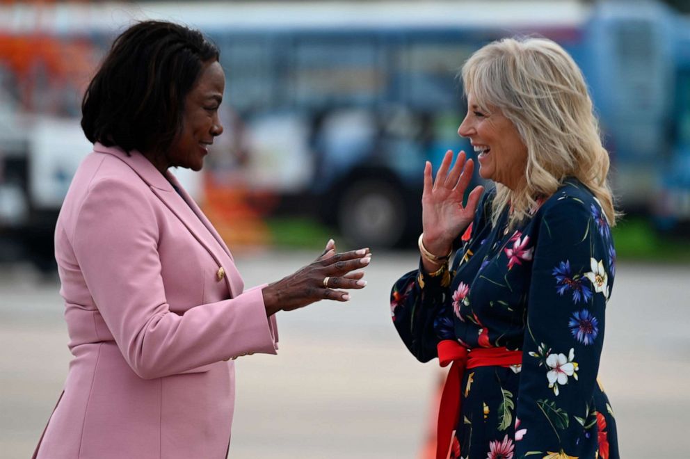 PHOTO: First lady Jill Biden, right, is greeted by Rep. Val Demings, left, D-Fla., as she arrives in Orlando, Fla., Thursday, July 8, 2021, to attend the 2021 Scripps National Spelling Bee Finals.