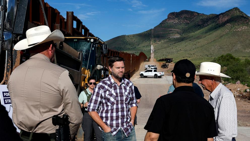 PHOTO: Republican vice presidential nominee Sen. JD Vance talks with Sheriff Robert Watkins of Cochise County while touring the Border Wall, Aug. 1, 2024, in in Montezuma Pass, Ariz.