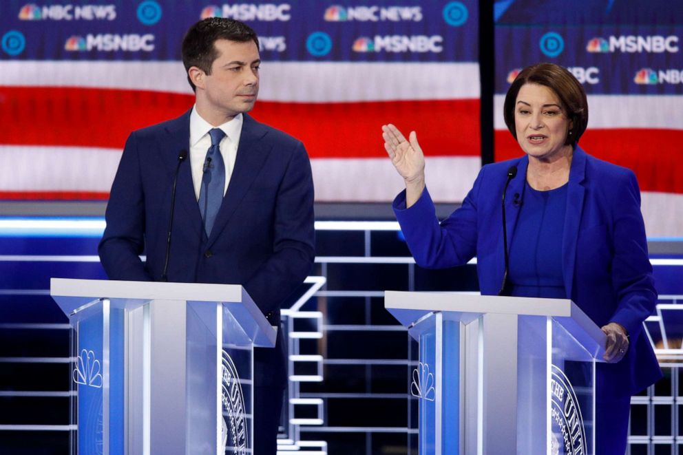 PHOTO: Democratic presidential candidates former South Bend Mayor Pete Buttigieg, left, looks on as Sen. Amy Klobuchar, D-Minn., speaks during a Democratic presidential primary debate, Feb. 19, 2020, in Las Vegas.