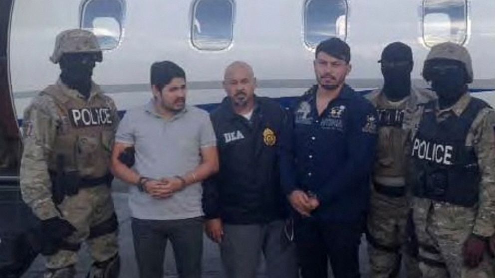PHOTO: Efrain Antonio Campo Flores, second from left, and Franqui Fancisco Flores de Freitas stand with law enforcement officers in this Nov. 12, 2015, photo after their arrest in Port Au Prince, Haiti.