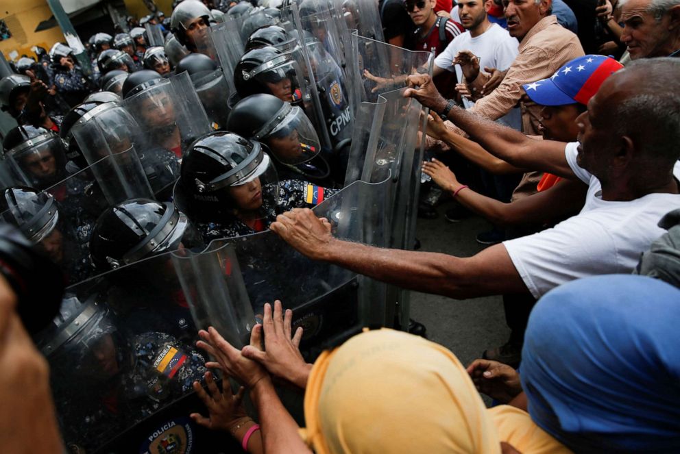 PHOTO: In this March 10, 2020, file photo, demonstrators scuffle with security forces during a protest in Caracas, Venezuela.