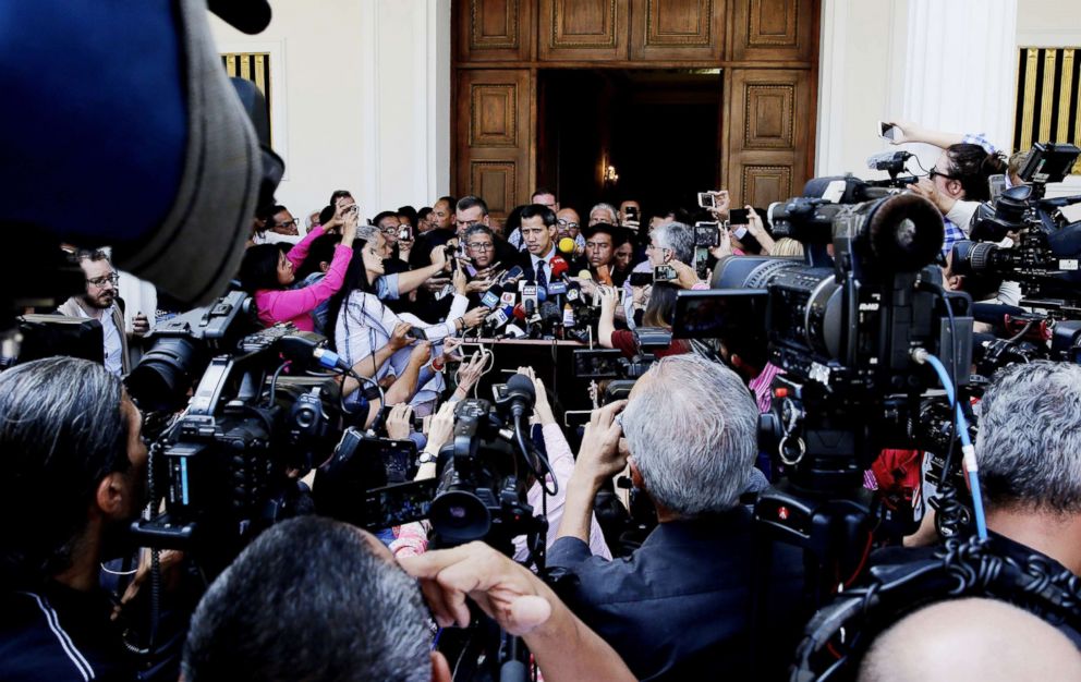 PHOTO: The president of the Venezuelan National Assembly Juan Guaido (C) speaks to the press as he arrives at the Parliament headquarters, in the Federal Legislative Palace, in Caracas, Venezuela, Jan. 29, 2019.