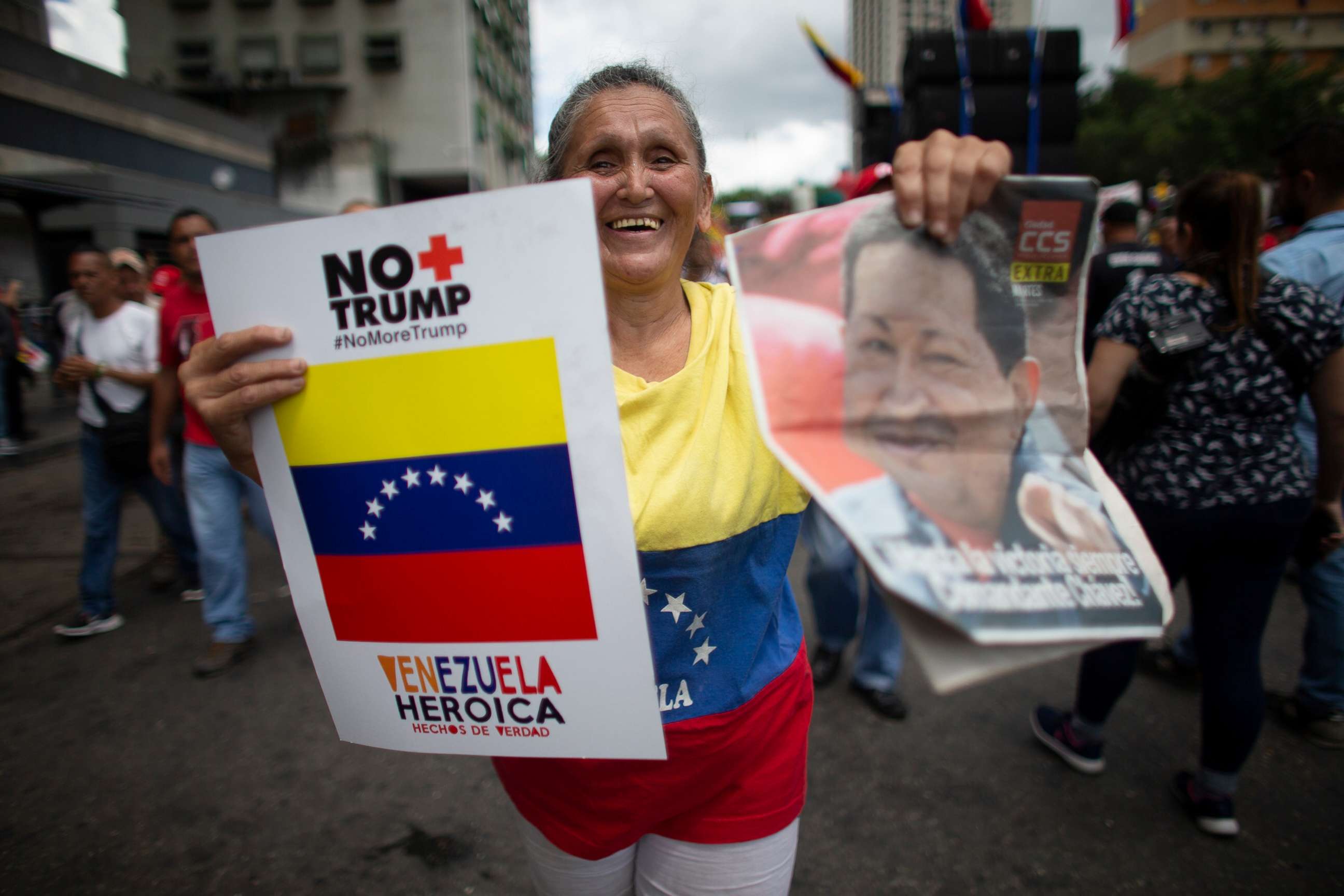 PHOTO: A supporter of President Nicolas Maduro holds a poster that in Spanish reads "No more Trump" and an image of Late President Hugo Chavez, during an anti-imperialist rally in Caracas, Venezuela, August 31, 2019.