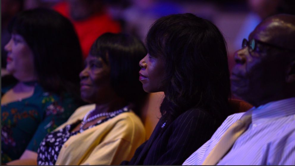 PHOTO: Vennia Francois sits with family and friends in church.