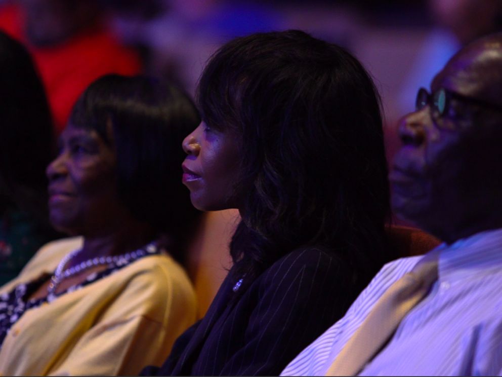 PHOTO: Vennia Francois sits with family and friends in church.