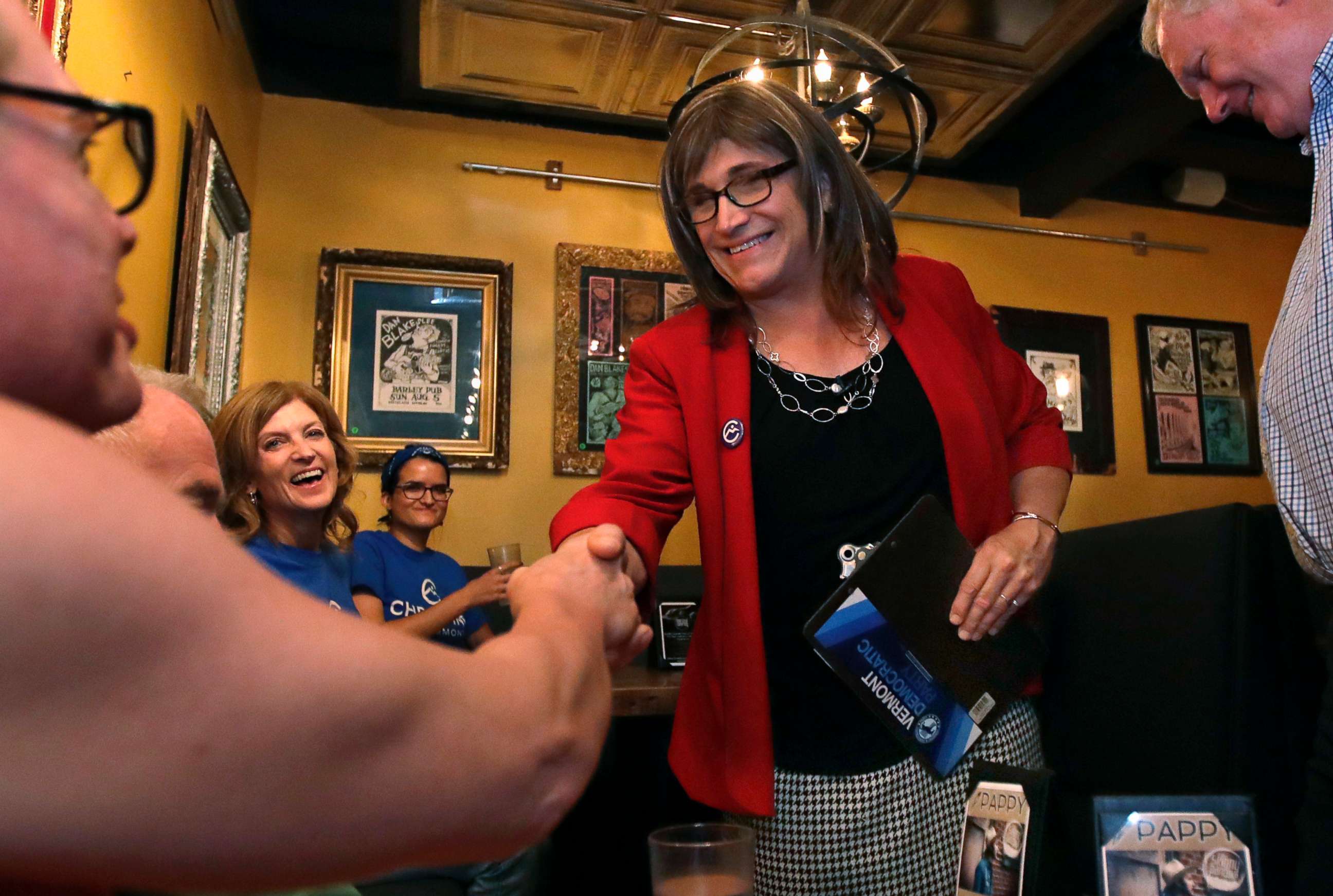 PHOTO: Vermont Democratic gubernatorial candidate Christine Hallquist, holding clipboard, a transgender woman and former electric company executive, shakes hands with her supporters during her election night party in Burlington, Vt., on Aug. 14, 2018.