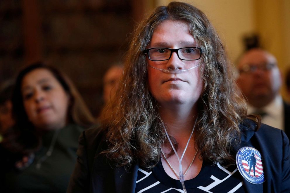 PHOTO: Megan Kingston, who served as a medic in Iraq, wears an oxygen tube as she listens to a House Veterans' Affairs Health Subcommittee hearing on potential health effects of burn pit exposure among veterans, June 7, 2018, in Washington.