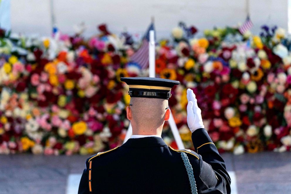 PHOTO: A tomb guard of the 3rd US Infantry Regiment, known as "The Old Guard," salutes before a centennial ceremony for the Tomb of the Unknown Soldier, in Arlington National Cemetery, on Veterans Day, Nov. 11, 2021, in Arlington, Va.