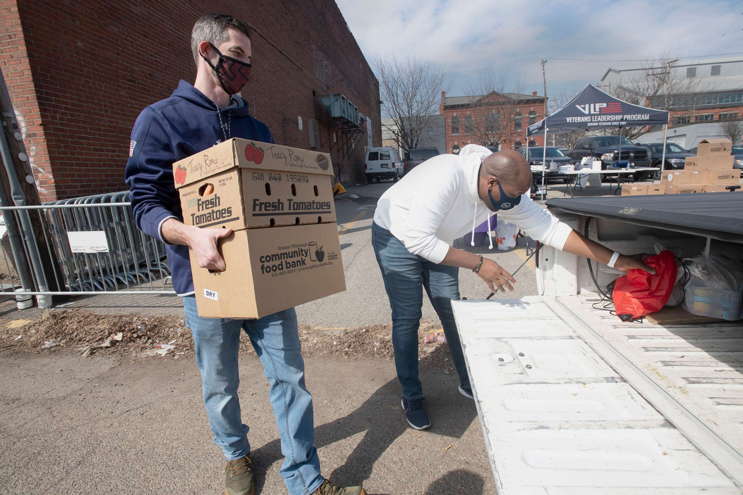 PHOTO: Volunteers load boxes of goods into a truck during the Veterans Leadership Program's (VLP) monthly Military Share Food Distribution at their Strip District location on March 8, 2021, in Pittsburgh. 