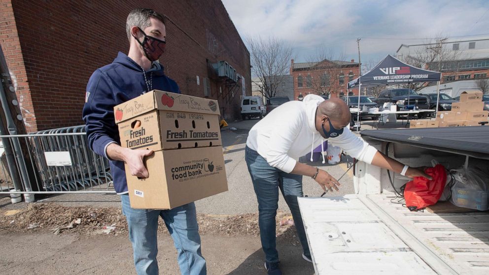 PHOTO: Volunteers load boxes of goods into a truck during the Veterans Leadership Program's (VLP) monthly Military Share Food Distribution at their Strip District location on March 8, 2021, in Pittsburgh. 