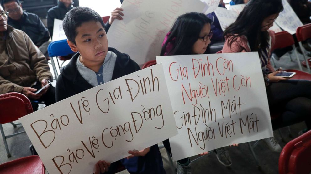 Outcry Over Refugee Deportations As Trump Visits Vietnam For Summit Bill Nguyen 12 And Jade 9 Hold Signs At A Rally