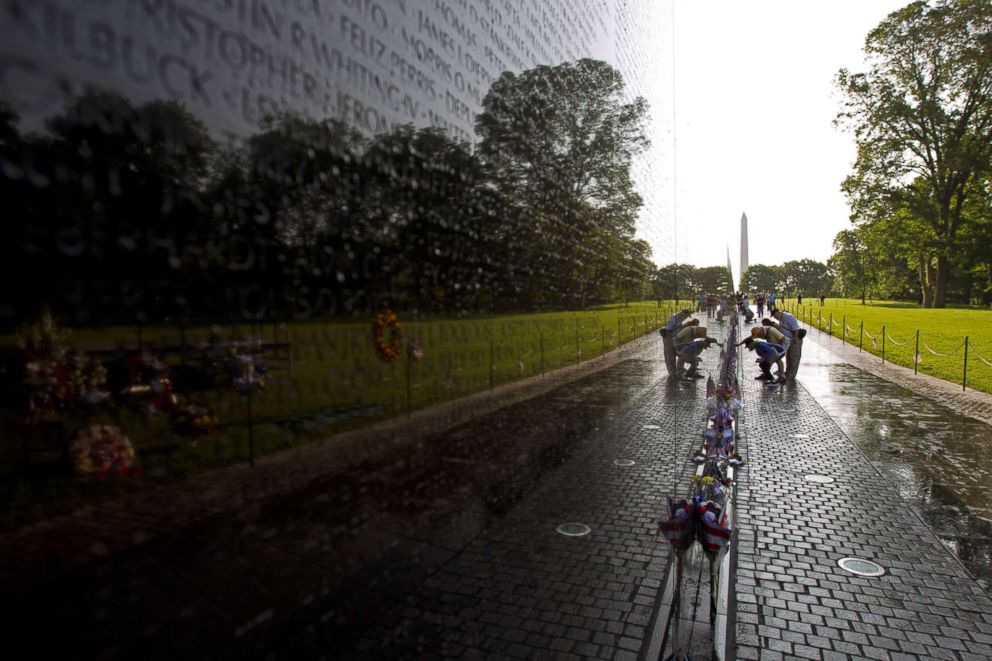 PHOTO: Visitor looks the names on the wall of the Vietnam Veterans Memorial in Washington DC, May 28, 2017.