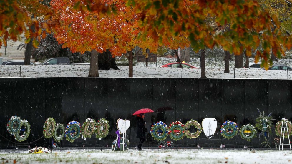 PHOTO: A visitor to the Vietnam Veterans Memorial during an early snowfall in Washington, D.C., Nov. 15, 2018.