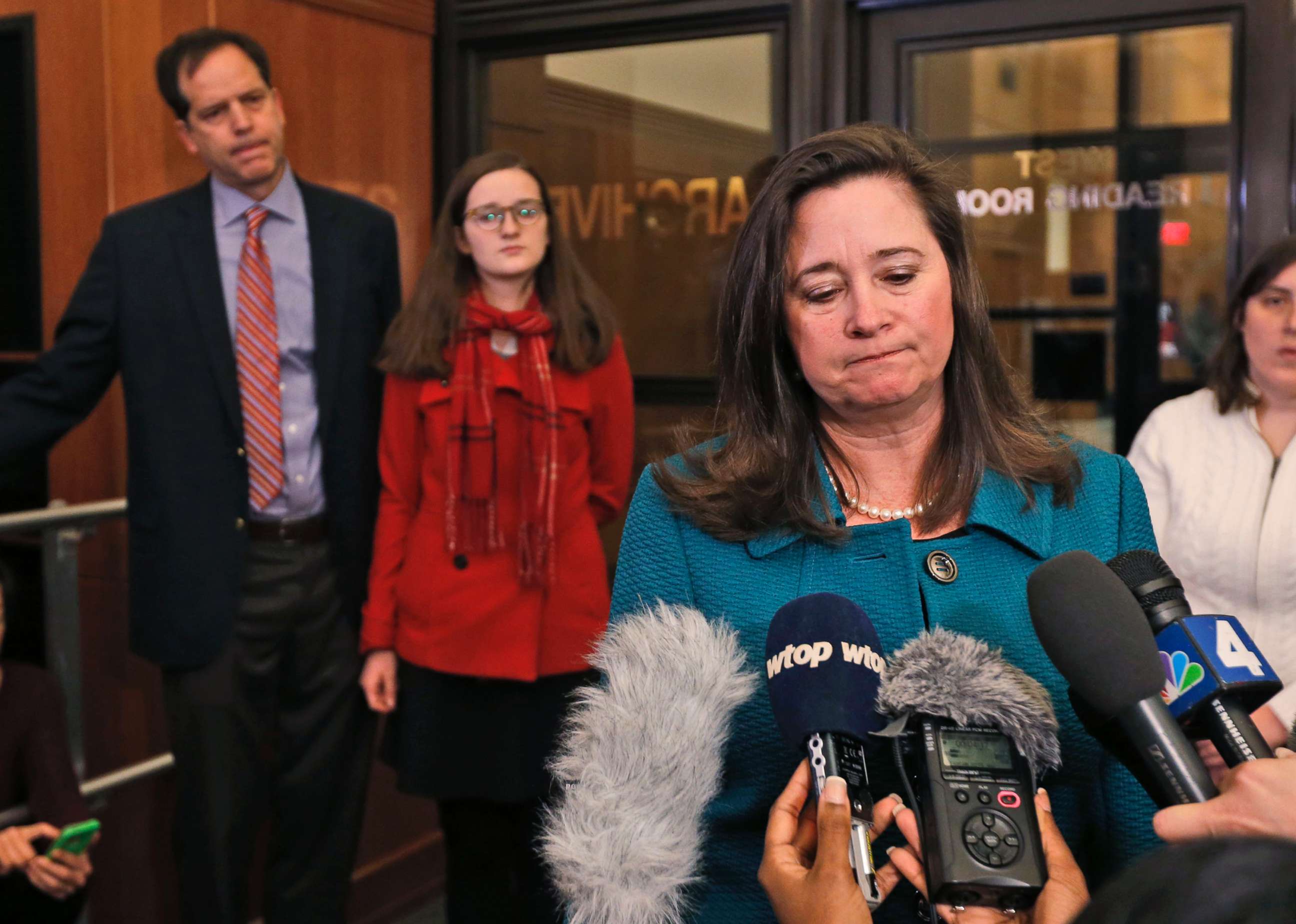 PHOTO: Democratic candidate Shelly Simonds, speaks to the press as her husband, Paul Danehy, left, and daughter, Georgia Danehy, listen after a drawing to determine the winner of a tied election at the Capitol in Richmond, Va., Jan. 4, 2018. 