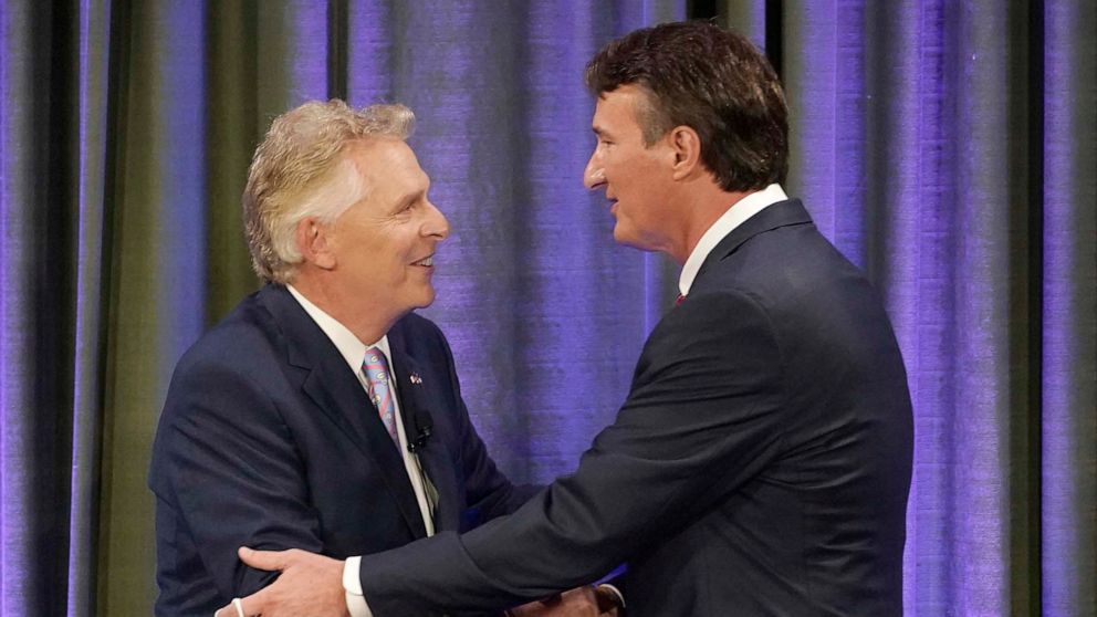 PHOTO: Democratic gubernatorial candidate former Governor Terry McAuliffe, left, greets Republican challenger, Glenn Youngkin, at the start of a debate at the Appalachian School of Law in Grundy, Va., Sept. 16, 2021. 