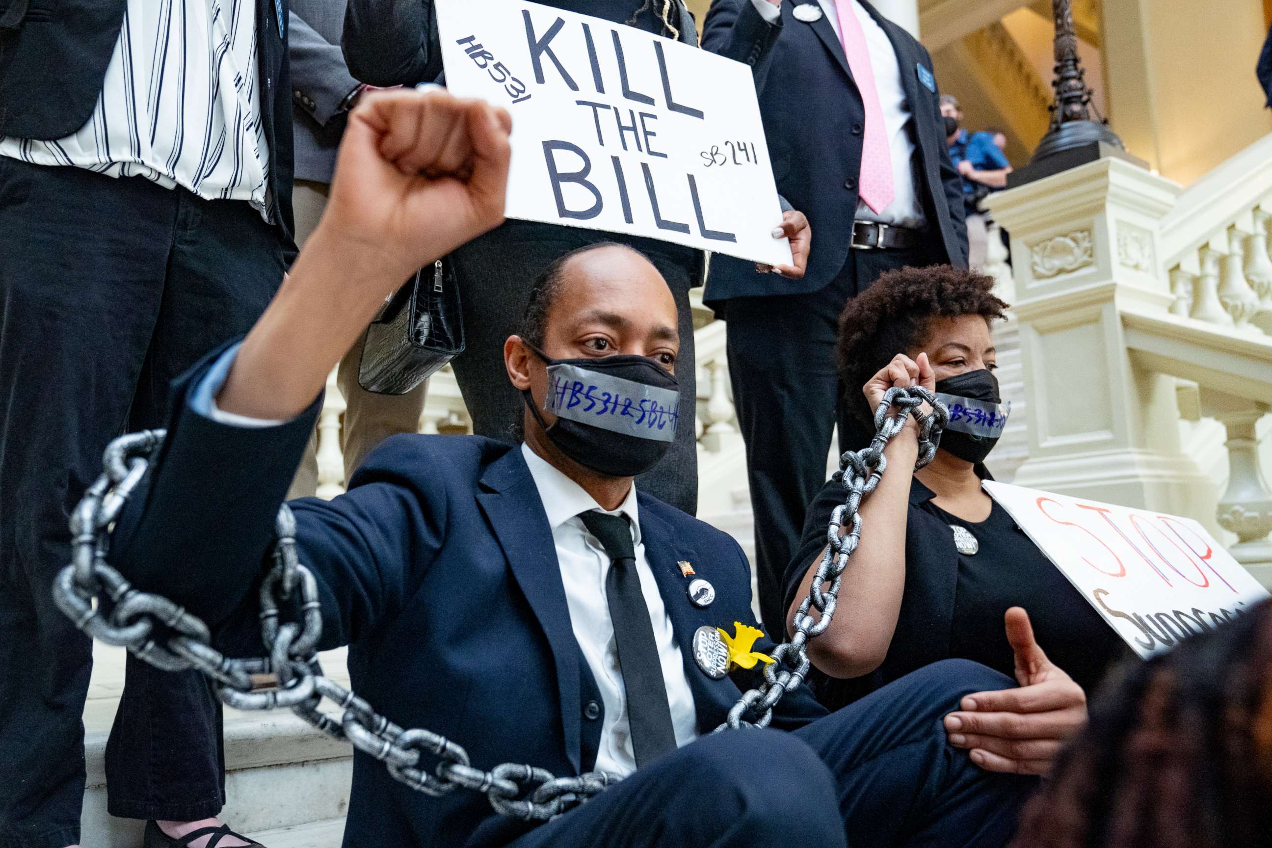 PHOTO: Demonstrators wear chains, March 8, 2021, while holding a sit-in inside of the Capitol building in Atlanta, in opposition of House Bill 531, one of the bills the GOP-led state legislature has been considering that would limit voting rights.