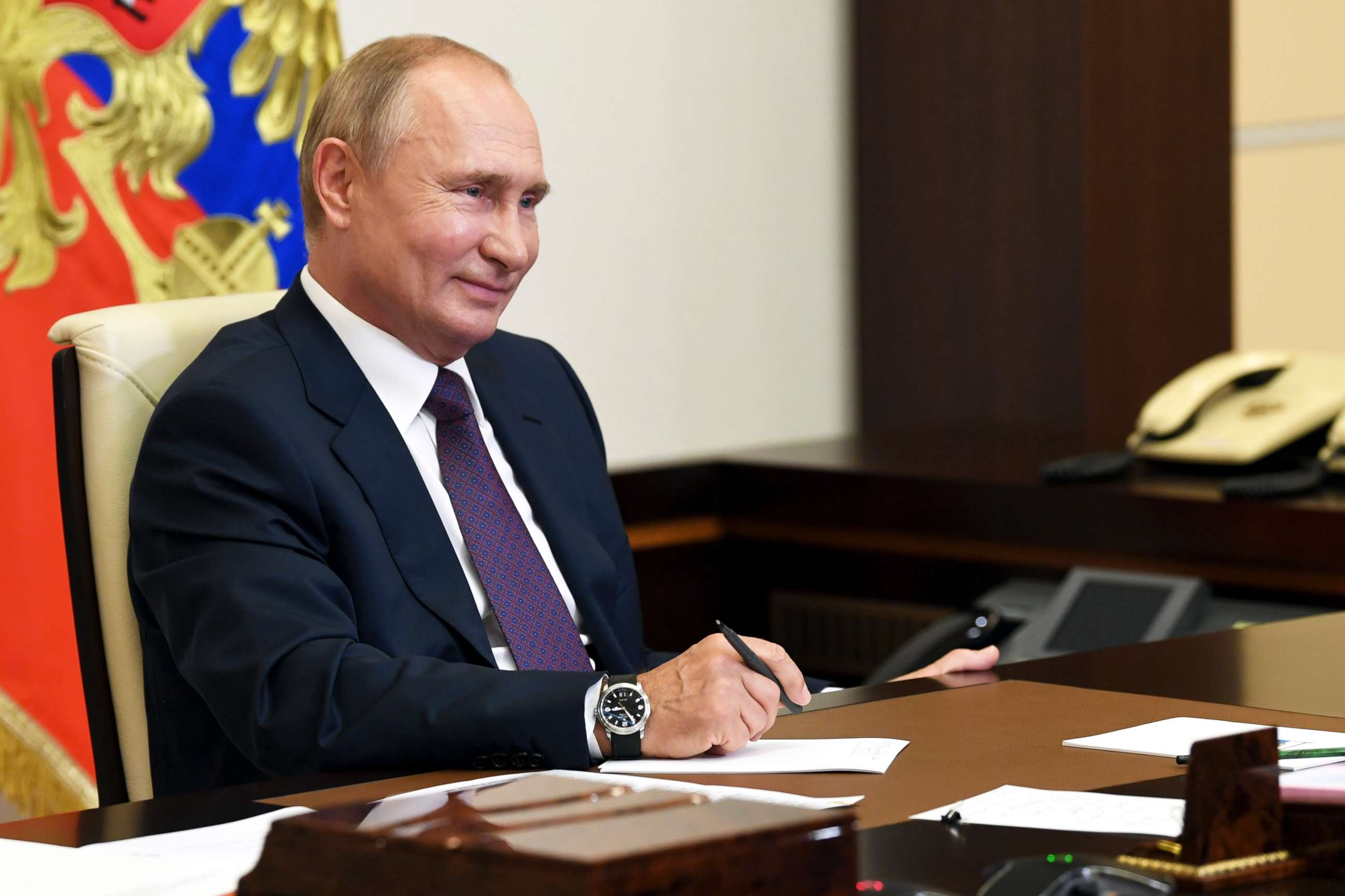 PHOTO: Russian President Vladimir Putin smiles as he attends a meeting via video conference at the Novo-Ogaryovo residence outside Moscow, Russia, Aug. 20, 2020.