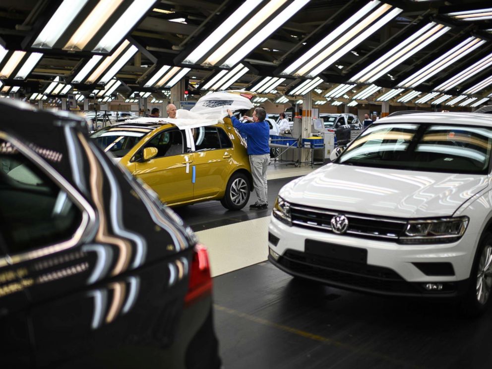 PHOTO: Workers assemble Volkswagen Golf cars at the Volkswagen factory on March 8, 2018 in Wolfsburg, Germany.