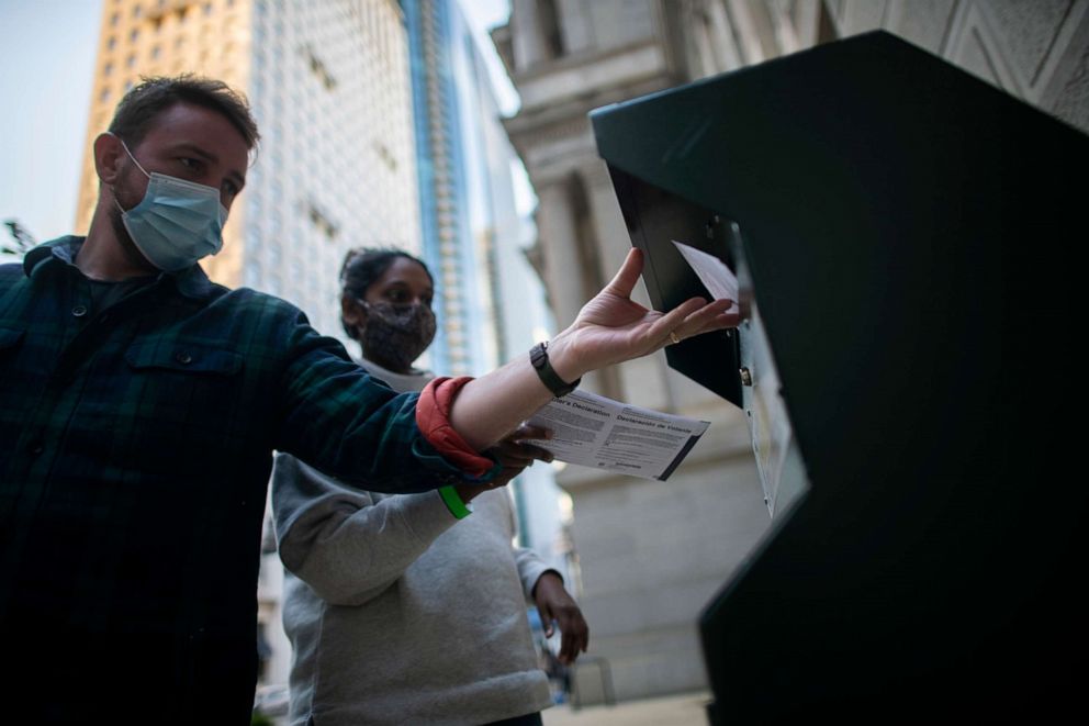 PHOTO: Voters cast their early voting ballot at a drop box outside of City Hall on Oct. 17, 2020 in Philadelphia.