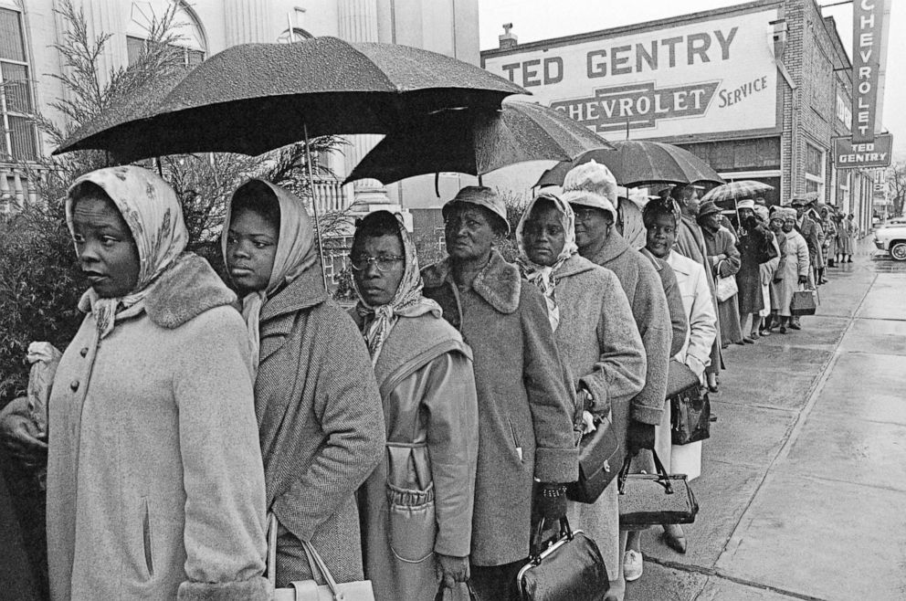 PHOTO: Black men and women stand in line in the rain while trying to register in a priority book to take a voter registration test in Selma, Ala., Feb. 17, 1965.