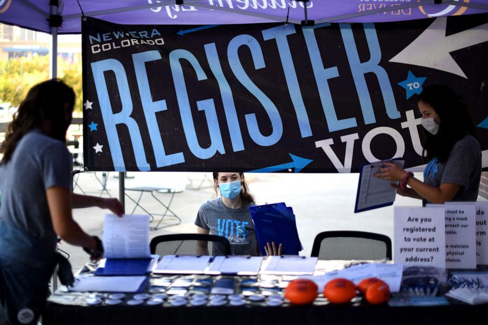 PHOTO: From left, Nicole Hensel, Aly Belknap and Raegan Cotton of New Era Colorado are trying to register college students to vote and answer voting logistics questions  at Auraria Campus in Denver, Sep. 22, 2020. 