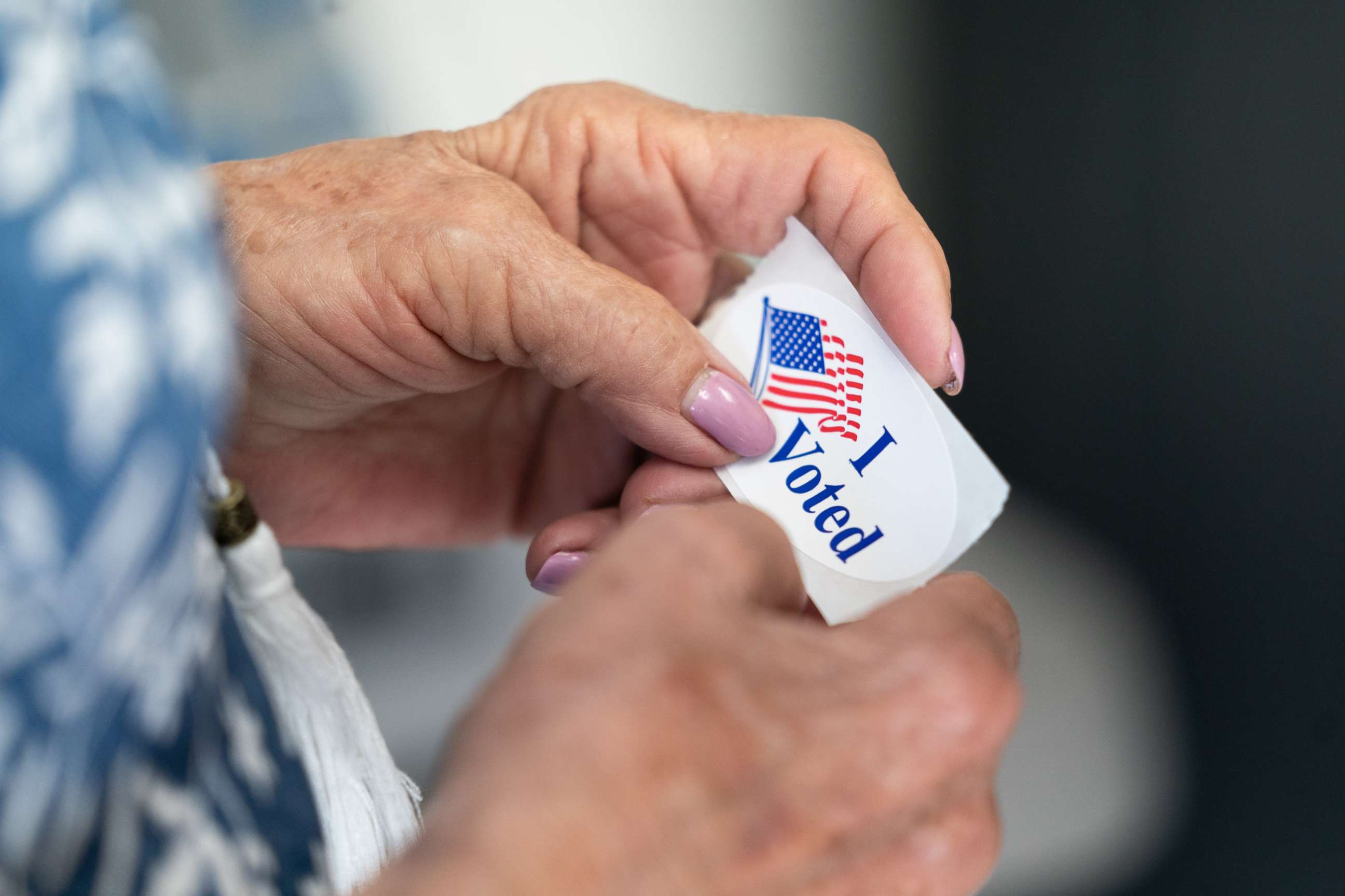 PHOTO: A poll worker holds a sticker that reads, I Voted on May 17, 2022 in Mt. Gilead, North Carolina.