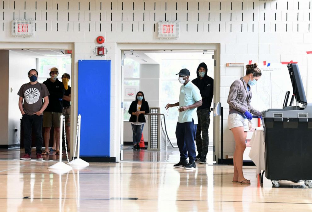 PHOTO: People gather to vote in the primary election at Columbia Heights Community Center on Tuesday June 02, 2020 in Washington.