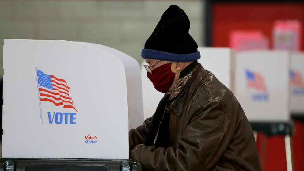 PHOTO: David Keltz wears a face mask as a precaution against the new coronavirus as he casts his vote in the 7th Congressional District special election at a voting center at Edmondson High School, April 28, 2020, in Baltimore.