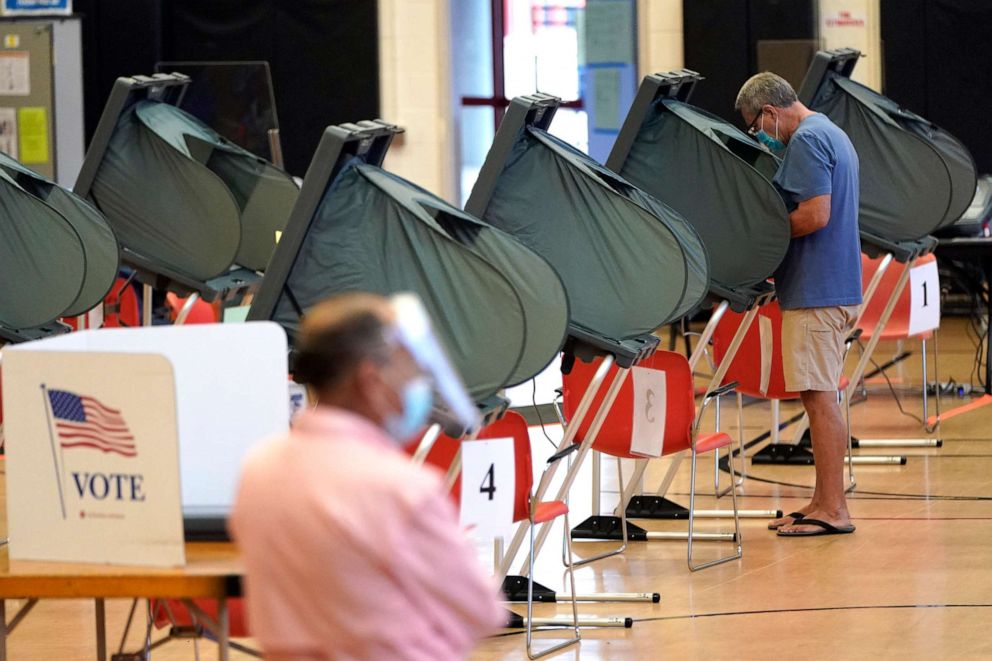 PHOTO: A man wears a mask while voting, June 29, 2020, in Houston. Early voting for the Texas primary runoffs began Monday.